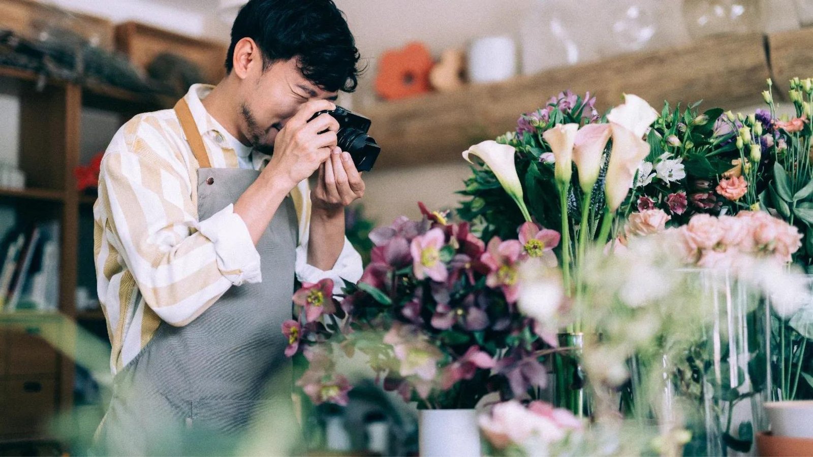 A man taking a photo of flowers showing Digital Marketing for Small Businesses in Fonni.
