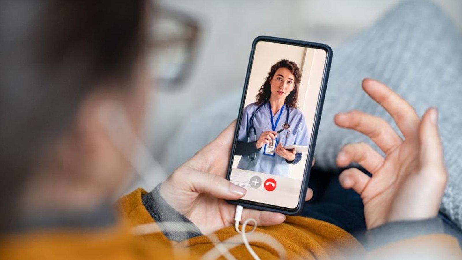 A health practitioner talking to a patient on a phone showing Telemedicine Adoption Among Health Practitioners in Fonni